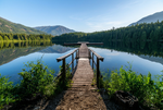 Load image into Gallery viewer, Daylight version of the wooden dock, lake, and mountains
